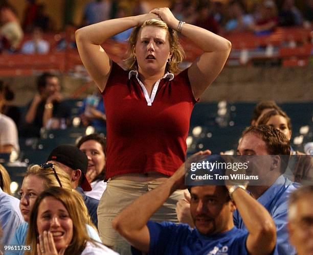 Teal Baker from the office Rep. Brian Baird, D-Wash., reacts to an out by the Dems during the Congressional Baseball game in which the Republicans...