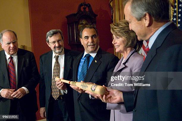 Joe Violante, Disabled American Veterans, presents a baseball bat to Speaker Nancy Pelosi, D-Calif., Reps. John Spratt, D-S.C., left, David Obey,...