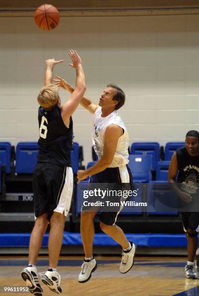 Sen. John Thune, R-S.D., blocks the shot of lobbyist Paul Miller at the 8th annual Hoops for Hope charity basketball game featuring members of...