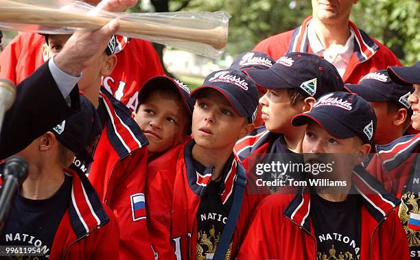 Kozin Alekisey center, and othr members of the the Russian Youth All-Star Team, wait to receive a new bat that was presented to him by Sen. Jim...