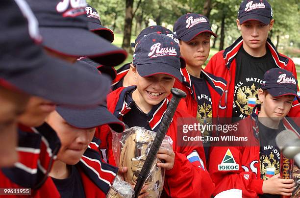 Kozin Alekisey of the the Russian Youth All-Star Team, gets a kick out of his new glove that was presented to him by Sen. Jim Bunning and Jack and...