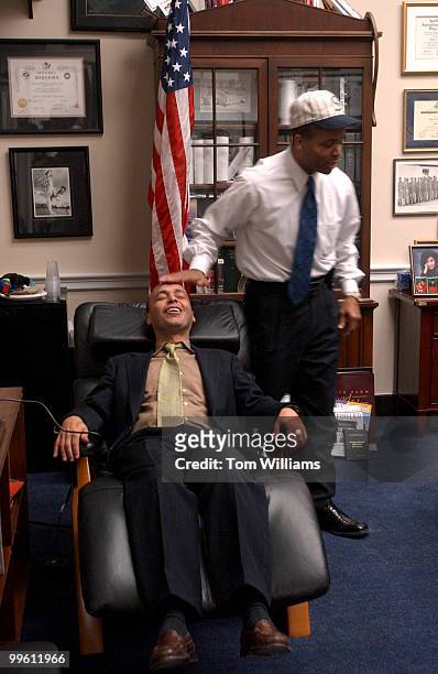 Rep. Luis Gutierrez, D-Ill., relaxes in a massaging chair in the office of Rep. Jesse Jackson Jr., before a pay off for a bet made on the World...