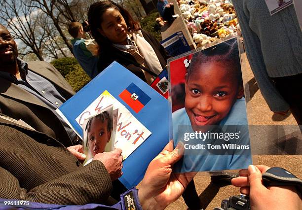 Dr. Joe Kraft, of Texas, holds a picture of Salou that is one of 5 children the Kraft family wants to adopt but they are stuck in Haiti. In the...