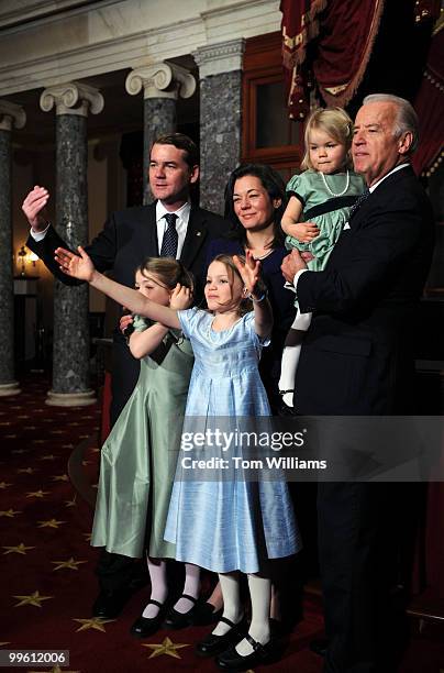 Sen. Michael Bennet, D-Colo., left, encourages the rest of his family up for a picture with his daughters Halina left, and Caroline Anne wife Susan...