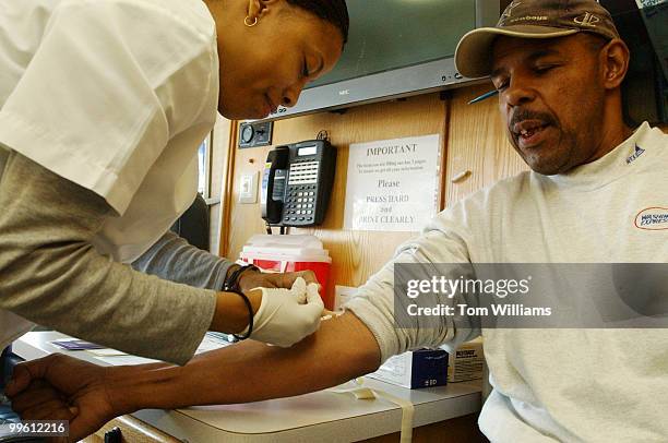 Howard Dublin has blood drawn by Kanika Johnson, as part of a a free prostate cancer screening, Wednesday, outside Russell Building. The screenings...