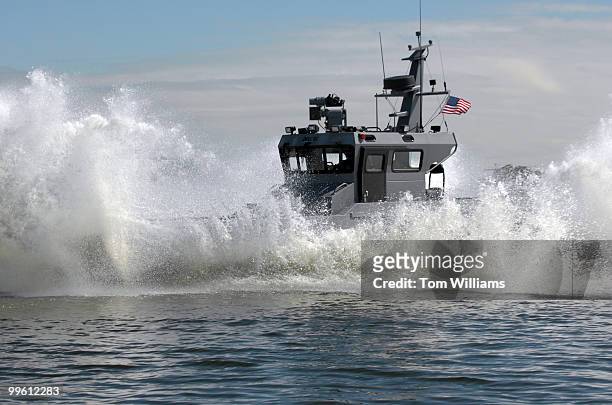 Combat boat named Joint Multimission Expeditionary Craft , performs a "bucket drop" in the Potomac River. The maneuver stops the boat from full speed...