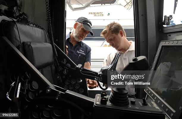 Tom Floyd, left, and Kerry Chadderton, check out the cabin of a combat boat named Joint Multimission Expeditionary Craft , in the Potomac River....