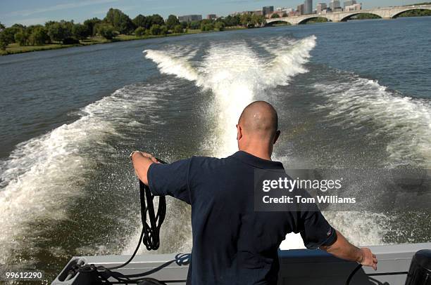 Andrew Hurst of Northrop Grumman, coils rope aboard a combat boat named Joint Multimission Expeditionary Craft , in the Potomac River. The JMEC is...