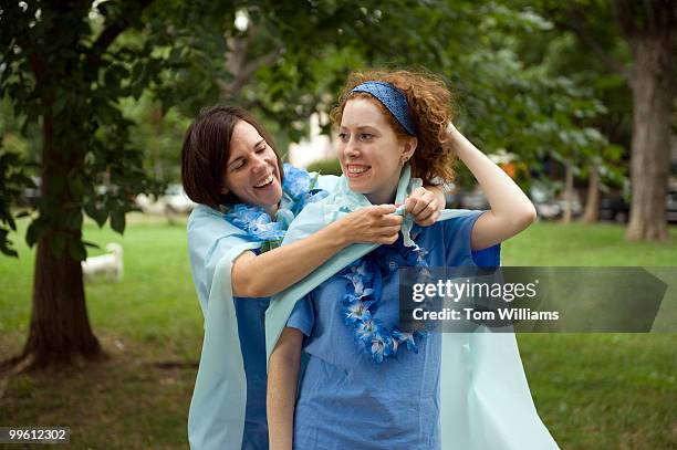 Connie Frigo, left, adorns her teammate from Bachi Bandits Andrea Dono, with flare before their bocce ball game in Garfield Park on Capitol Hill,...