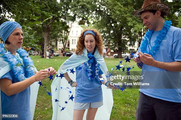 Teammates from Bachi Bandits from left, Margaret Krauss, Andrea Dono, and Alex Post, adorn themselves with flare before their bocce ball game in...