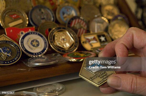 Sen. Kit Bond, R-Mo., talks about coins made by his office to give visitors. This one was made for former Chairman of the Joint Chiefs of Staff,...