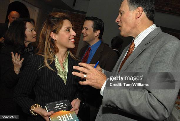 Rep. Jay Inslee, right, speaks with Pilar Rivera of Alteeva, during a party for his and Bracken Hendricks', center, new book, "Apollo's Fire:...