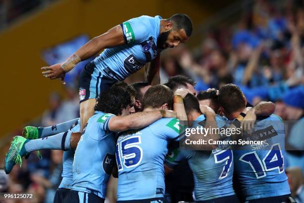 James Tedesco of the Blues celebrates with Josh Addo-Carr of the Blues and team mates after scoring a try during game three of the State of Origin...