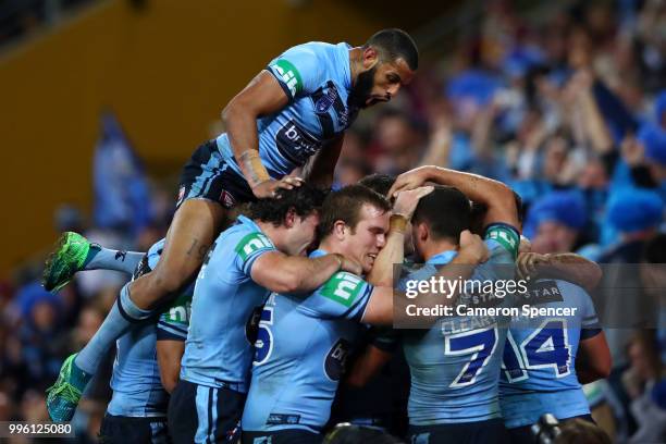 James Tedesco of the Blues celebrates with Josh Addo-Carr of the Blues and team mates after scoring a try during game three of the State of Origin...