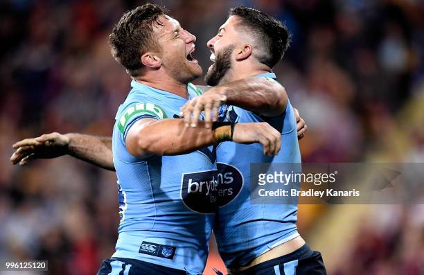 James Tedesco of the Blues celebrates with team mate Ashton Sims after scoring a try during game three of the State of Origin series between the...