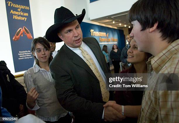 Country singer Garth Brooks talks to fans in the Smithsonian Air and Space Museum before a news conference where he donated items from his musical...