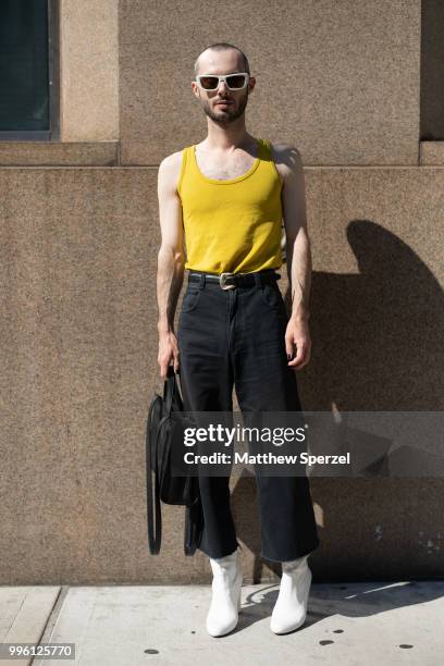 Sean Santiago is seen on the street attending Men's New York Fashion Week wearing Rachel Comey pants and thrifted on July 10, 2018 in New York City.