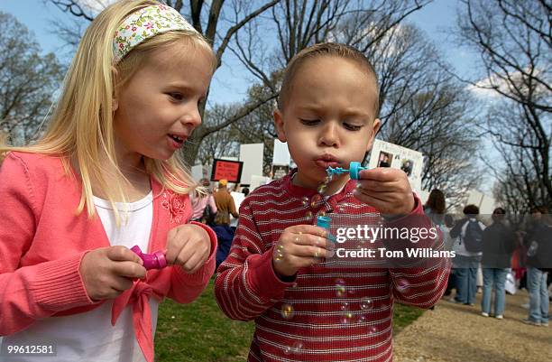 Journey and Jacoby Dent, 4 year old twins from Delaware, blow bubbles at a rally on the connection between childhood vaccines and autism. Jacoby was...