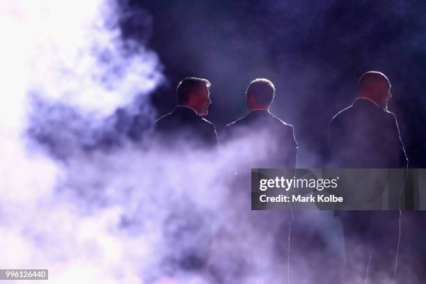 Shane Webke, Darren Lockyer and Gordon Tallis appears on stage during a "We love Queenslanders" Captain's Tribute during game three of the State of...