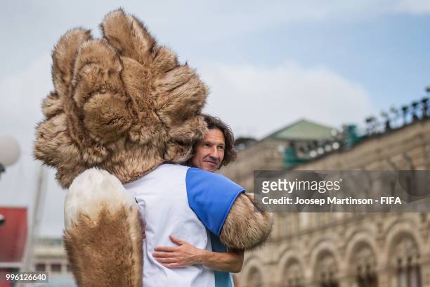 Alexey Smertin is being hugged by Zabivaka during the Legends Football Match in Red Square on July 11, 2018 in Moscow, Russia.