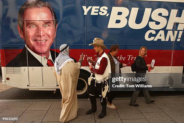 Anwar al-habub abd-al-shamns, left, and Laurel G.W. Sutherlin, believed an to be an aliases, stands outside the Yes Bush Can '04 bus that is touring...