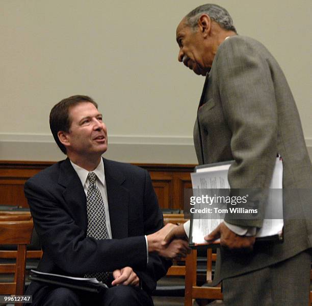 Former Deputy Attorney General James Comey, left, greets Chairman of the House Judiciary Committee John Conyers, D-Mich., before a hearing...