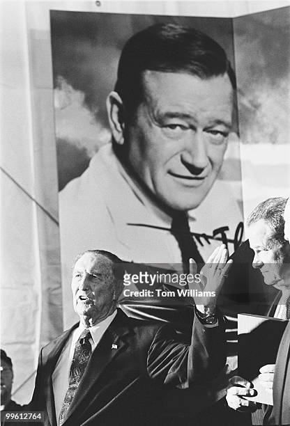 Sen. Strom Thurmond, R-S.C., and Rep. Newt Gingrich, R-Ga., appear in front of a helicopter with a poster of John Wayne.