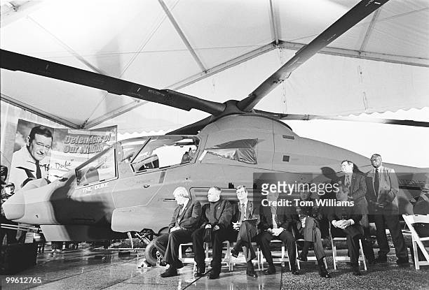 Sen. Strom Thurmond, R-S.C., and Rep. Newt Gingrich, R-Ga., appear in front of a helicopter with a poster of John Wayne.