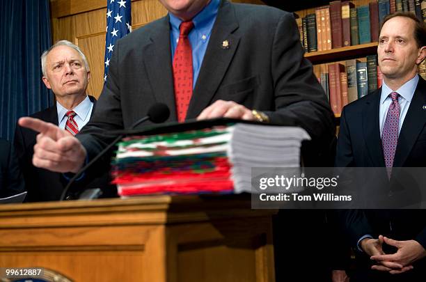 Reps. John Kline, R-Minn., left, and Dave Camp, R-Mich, listen to Rep. Frank Lucas, R-Okla., talk about the 1,100 page climate change legislation...