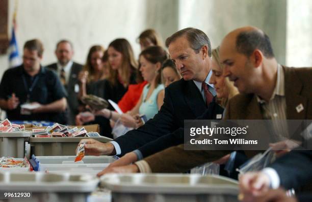 Rep. Chet Edwards, D-Texas, makes a care package for a military man or woman at a 'Stuffing Party' hosted by the USO, in Rayburn. The event resulted...