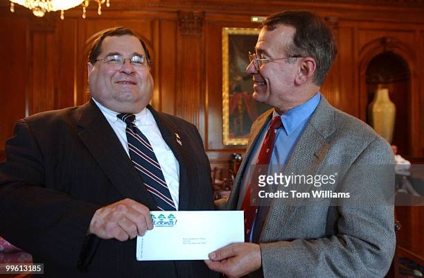 Rep. Jerry Nadler, D-N.Y., left, receives a check from Rep. Greg Ganske, R-Iowa, for rebuilding efforts in New York. The check in the amount...