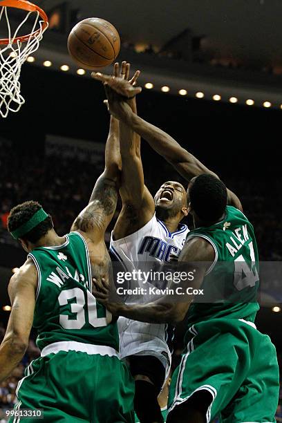 Vince Carter of the Orlando Magic loses the ball as he drives to the basket against Rasheed Wallace and Tony Allen of the Boston Celtics in Game One...