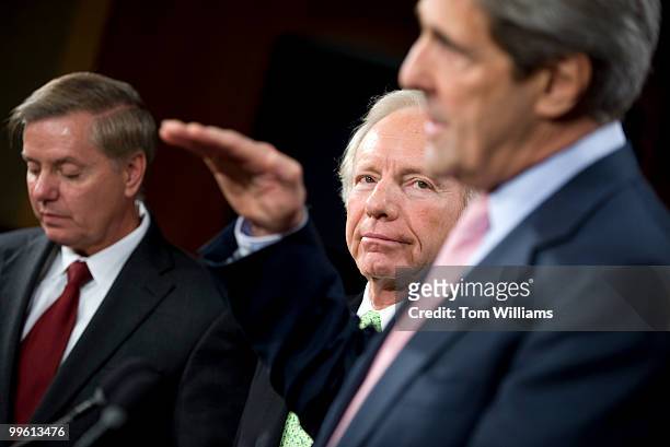 From left, Sens. Lindsey Graham, R-S.C., John Kerry, D-Mass., and Joe Lieberman, I-Conn., wrap up a news conference on climate change, Dec. 10, 2009.