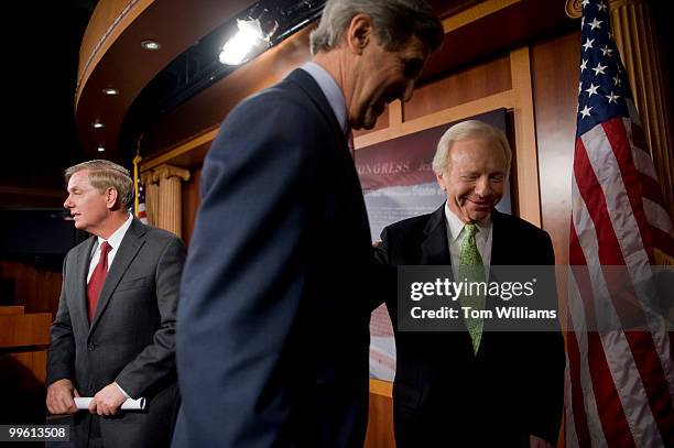 From left, Sens. Lindsey Graham, R-S.C., John Kerry, D-Mass., and Joe Lieberman, I-Conn., wrap up a news conference on climate change, Dec. 10, 2009.