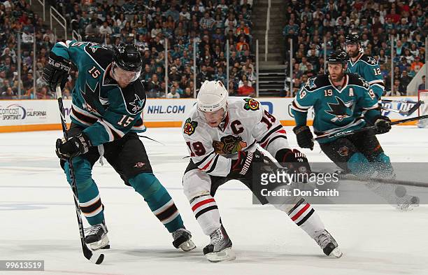 Jonathan Toews of the Chicago Blackhawks battles for the puck against Dany Heatley, Joe Thornton and Patrick Marleau of the San Jose Sharks in Game...