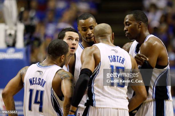 Jameer Nelson, J.J. Redick, Rashard Lewis, Vince Carter and Dwight Howard of the Orlando Magic huddle up against the Boston Celtics in Game One of...