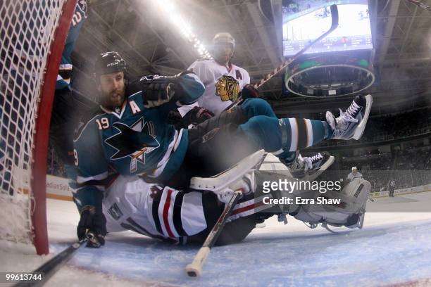 Joe Thornton of the San Jose Sharks falls on goaltender Antti Niemi of the Chicago Blackhawks in the seocnd period of Game One of the Western...