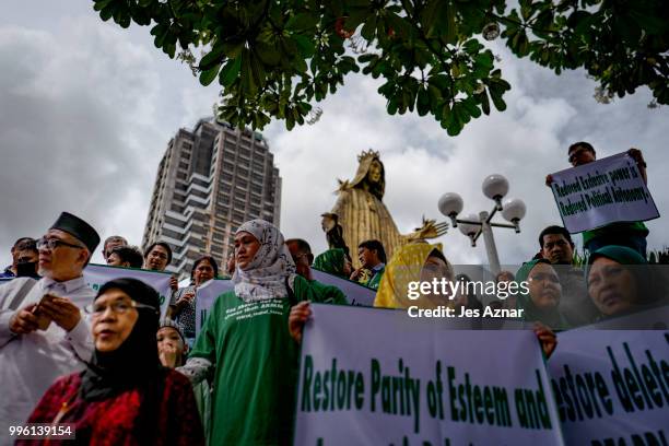 Muslim and Christian activists hold a picket during the bicameral talks between Philippine senate and congress that would determine the fate the...