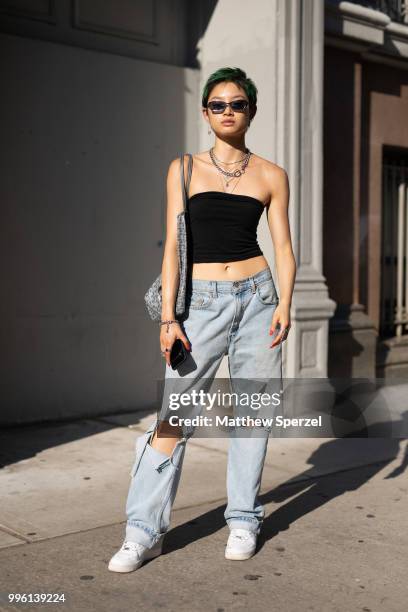 Joyce Mao is seen on the street attending Men's New York Fashion Week wearing vintage Levis, Air Force shoes on July 10, 2018 in New York City.