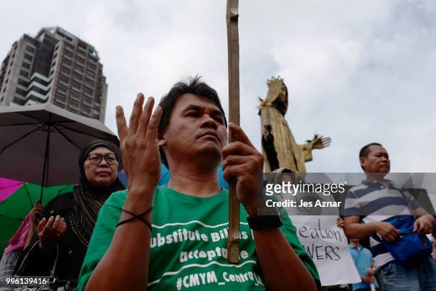 Muslim and Christian activists hold a picket during the bicameral talks between Philippine senate and congress that would determine the fate the...