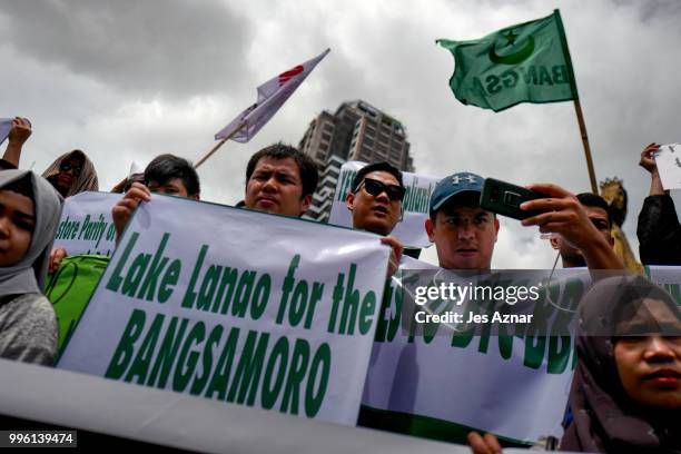 Muslim and Christian activists hold a picket during the bicameral talks between Philippine senate and congress that would determine the fate the...