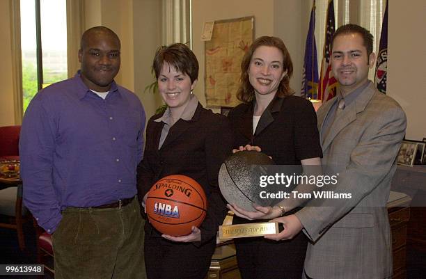 Climbers form left, Donny Wiliams, Ellie Heath, Jessica Katlin and Enrique Fernandez Roberts pose with basketballs from Senator Kohl's team, the...