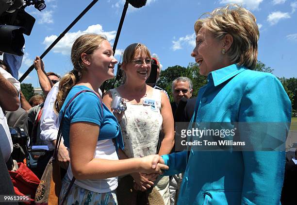 Sen. Hillary Clinton, D-N.Y., greets Kaia Alexander of Atlanta, and her mother Laura upon arriving at the senate steps before the senate luncheons,...