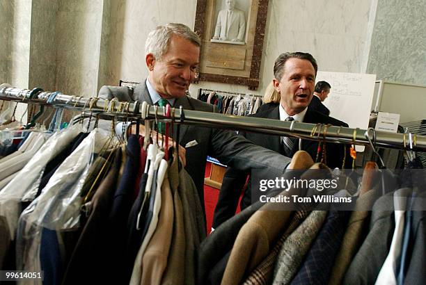 Reps. Mark Foley, R-Fla.,left, and Wally Herger, R-Calif., go through clothes donated to the first annual Capitol PurSUIT Drive which collected...