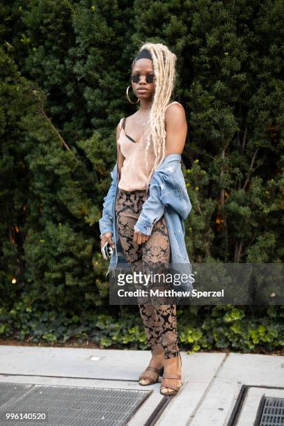 Joni is seen on the street attending Men's New York Fashion Week wearing denim jacket with ornate design pants on July 10, 2018 in New York City.