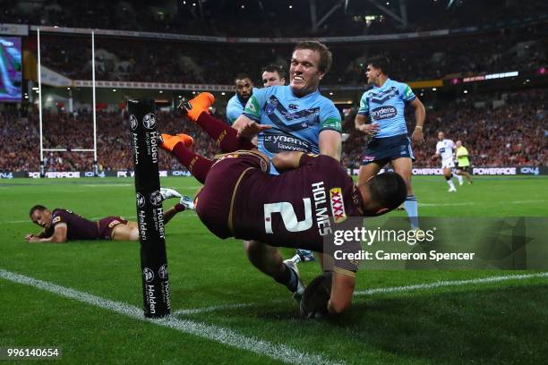 Valentine Holmes of Queensland scores a try during game three of the State of Origin series between the Queensland Maroons and the New South Wales...