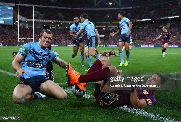 Valentine Holmes of Queensland scores a try during game three of the State of Origin series between the Queensland Maroons and the New South Wales...