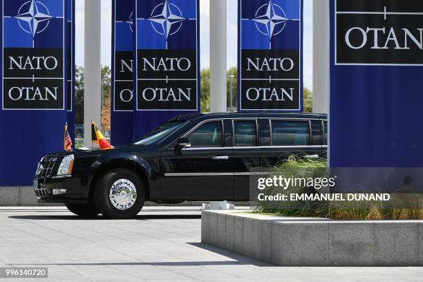 President Donald Trump arrives in the US official state car also known as The Beast, to attend the NATO summit, in Brussels, on July 11, 2018.