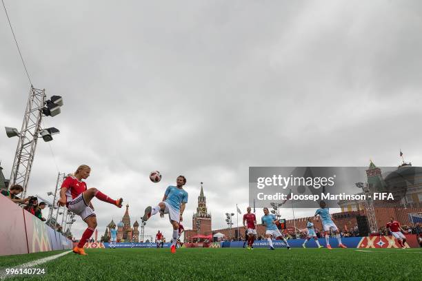 Marina Fedorova competes with Diego Forlan during the Legends Football Match in Red Square on July 11, 2018 in Moscow, Russia.