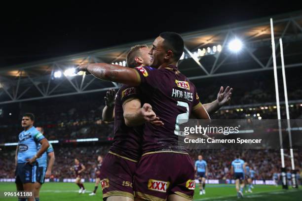Valentine Holmes of Queensland is congratulated by team mates after scoring a try during game three of the State of Origin series between the...